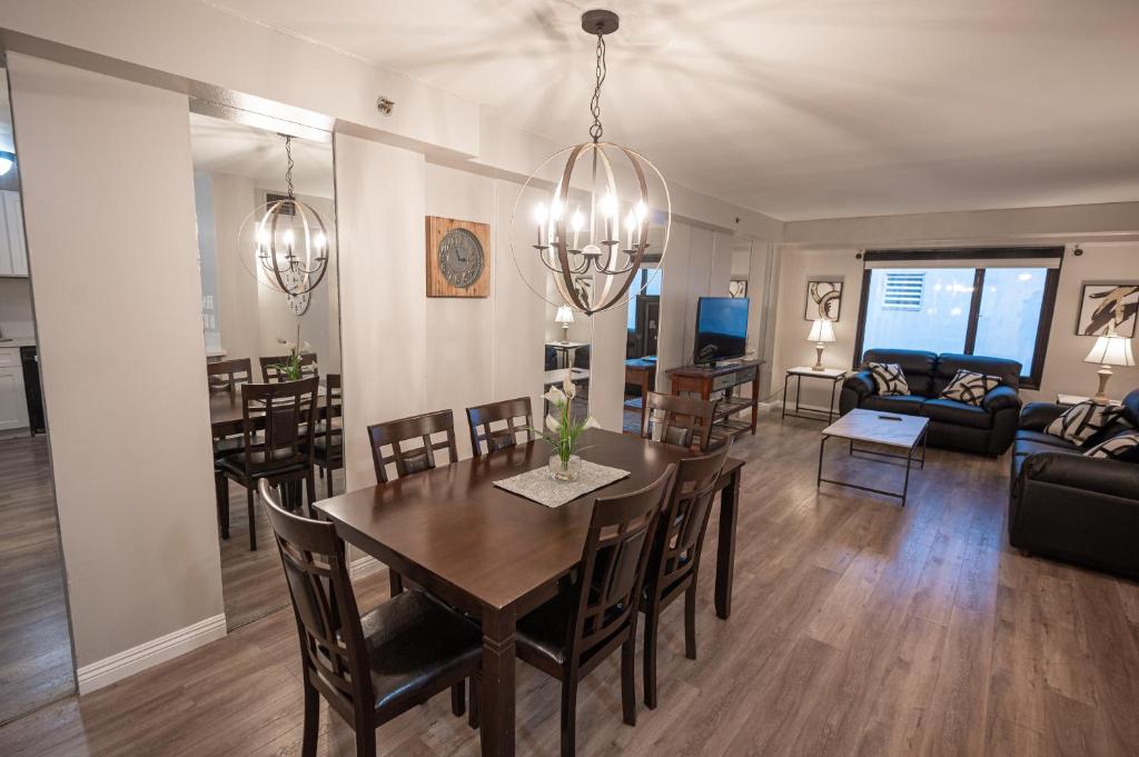 a dining room and living room with a table and chairs at Stay Together Suites on The Strip - 2 Bedroom Suite 976 in Las Vegas