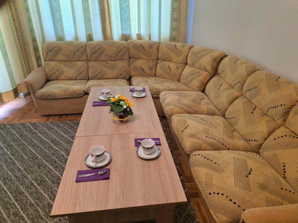 a living room with a table and a couch at ПРИНЦЕС in Burgas City