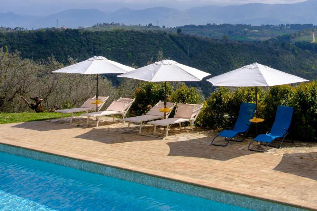 - un groupe de chaises longues et de parasols à côté de la piscine dans l'établissement Le Case Gialle, à Gualdo Cattaneo
