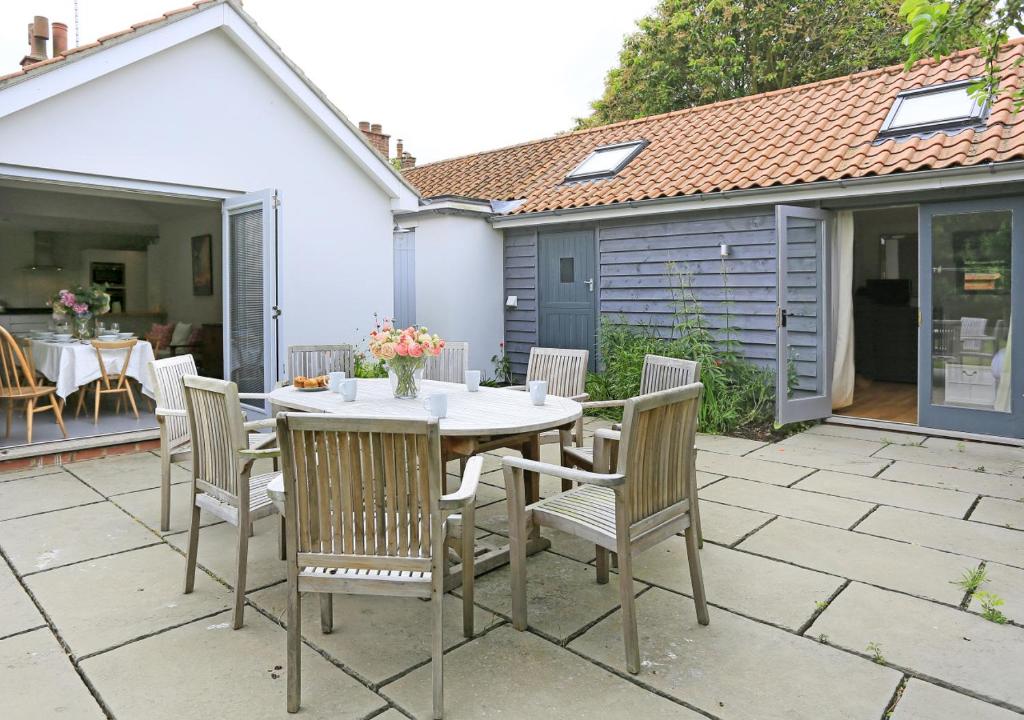 a table and chairs sitting on a patio at Little Meadow in Walberswick