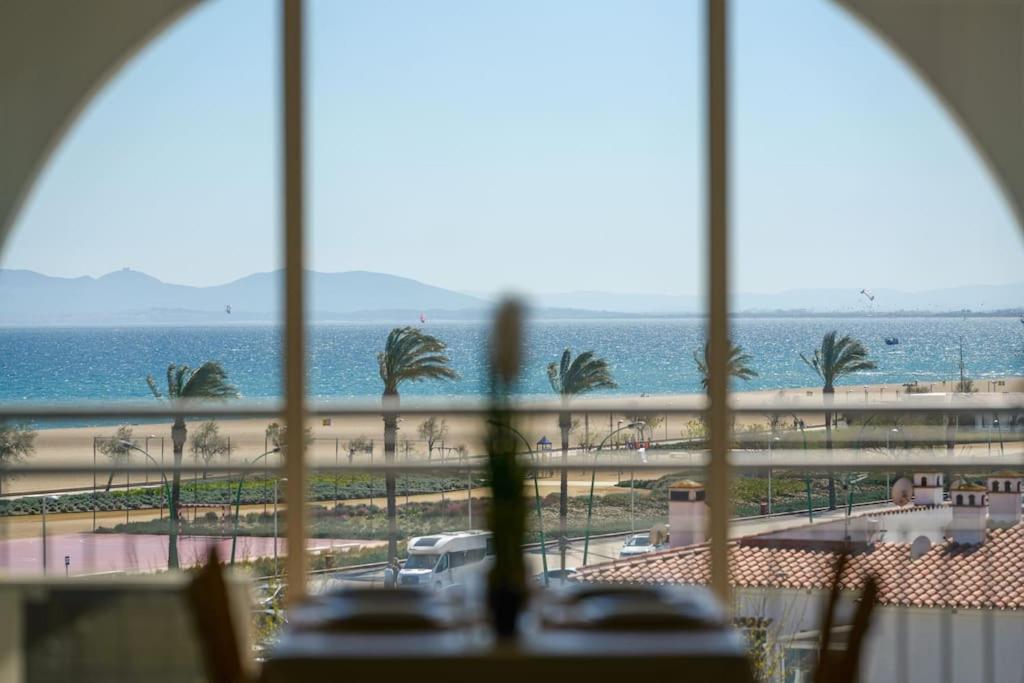 a view of the beach from a hotel window at Magnifique duplex, vue mer et canal by Welhomy in Empuriabrava
