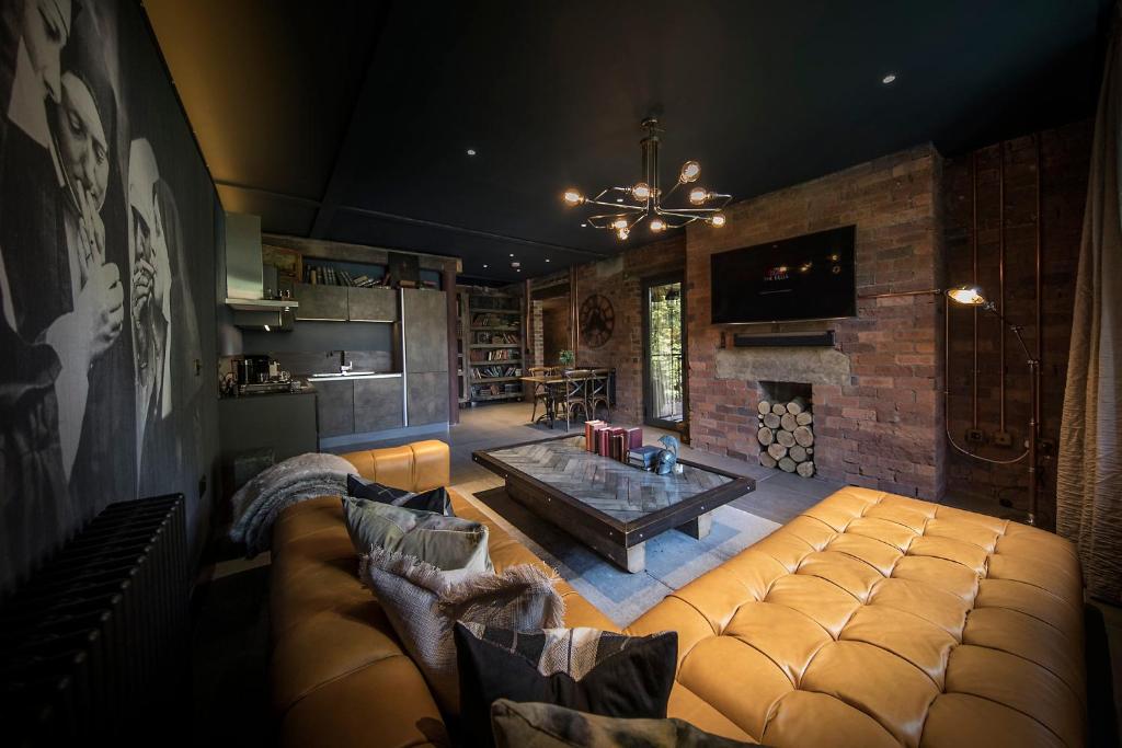 a living room with a couch and a table at The Bells - Luxury Serviced Apartments in Leeds