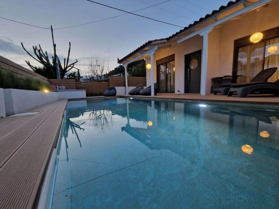 a swimming pool in front of a house at Orsalia villa wellness in Poros