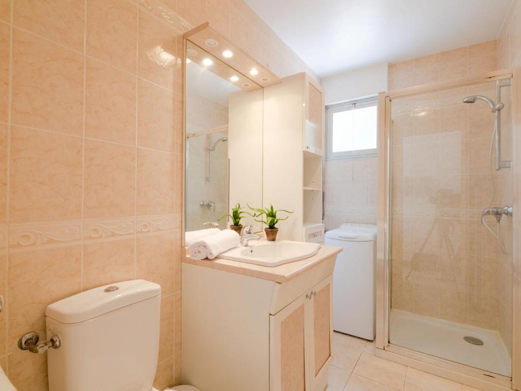 a bathroom with a toilet and a sink and a shower at Apartment Le Grand Large-1 by Interhome in Sainte-Maxime