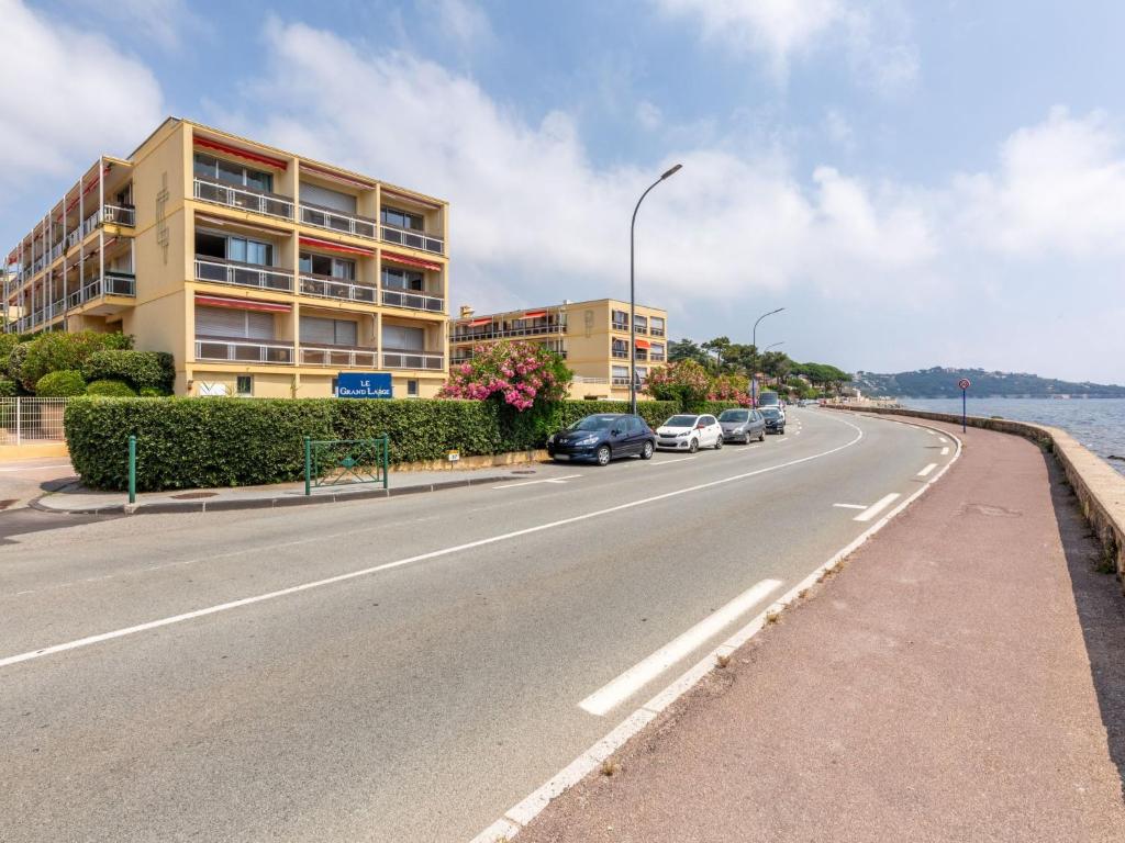 a street with cars parked on the side of a road at Apartment Le Grand Large-1 by Interhome in Sainte-Maxime