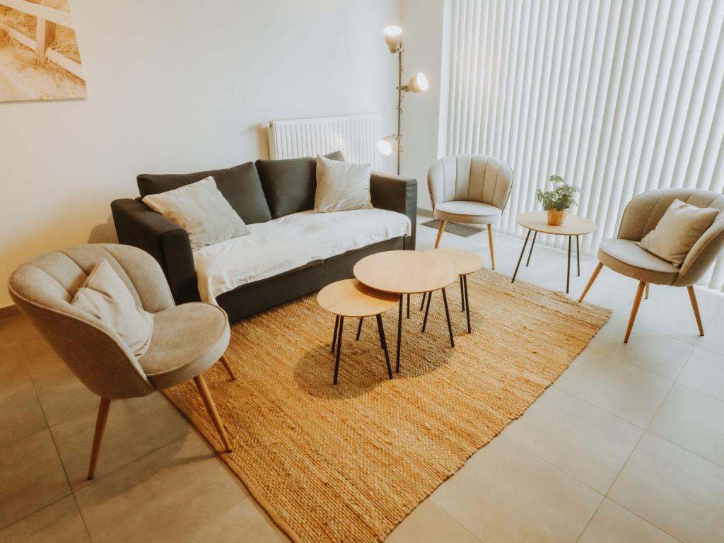 a living room with a couch and chairs and a rug at Apartment Rodenbach by Interhome in De Haan
