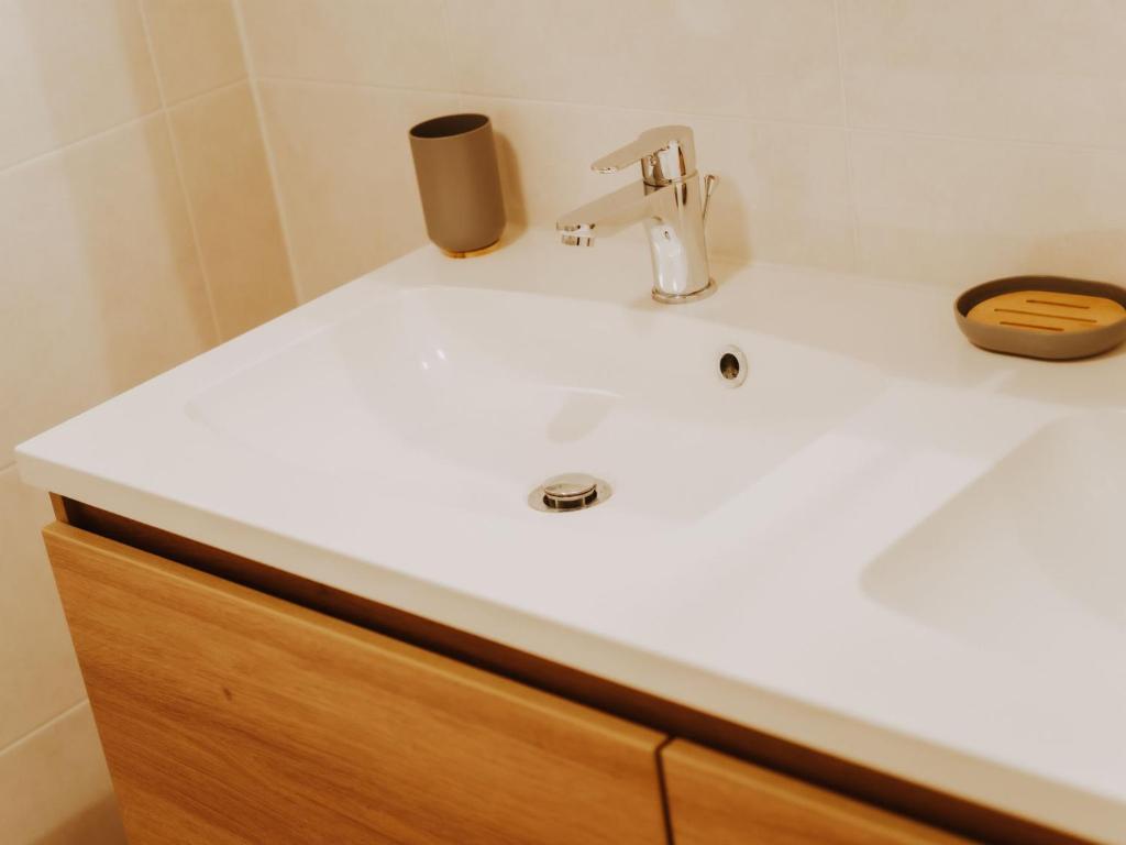 a bathroom sink with a faucet on top of it at Apartment Rodenbach by Interhome in De Haan