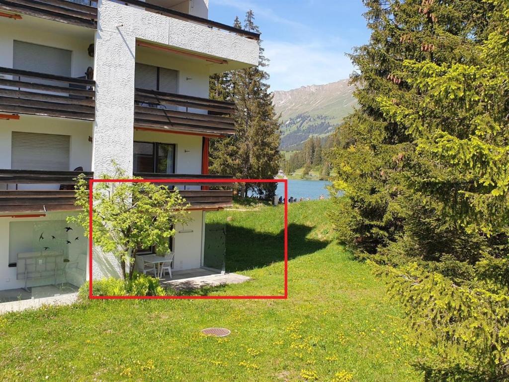 aterior view of a building with a view of a lake at Apartment Uehlinger Seegarten Wirz by Interhome in Lenzerheide