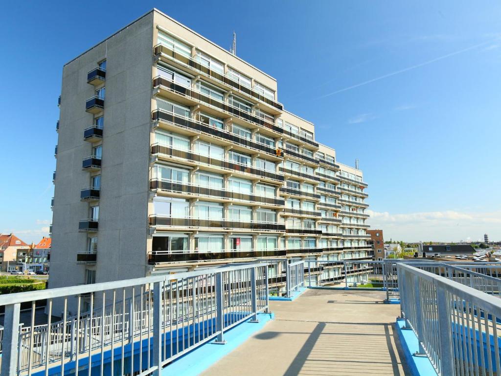 a large apartment building with a walkway in front of it at Studio Zeeduin by Interhome in Bredene