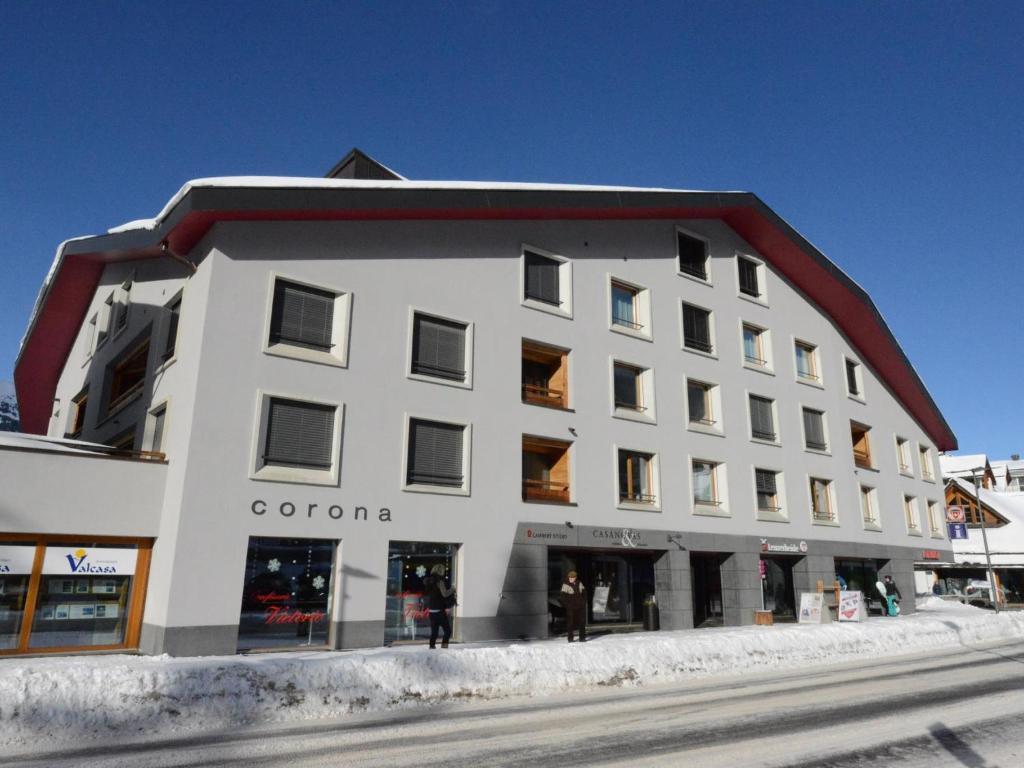 a white building with a red roof on a street at Apartment Uehlinger Rosana by Interhome in Lenzerheide