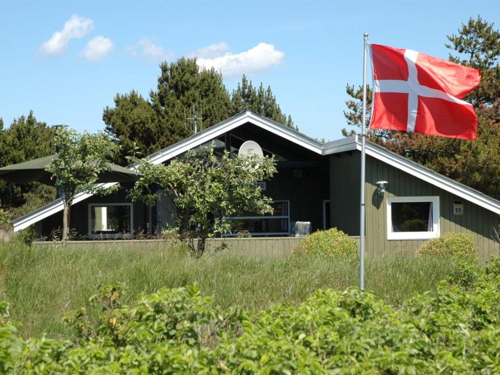 a flag flying in front of a house at Holiday Home Nilda - 1km from the sea in Western Jutland by Interhome in Vejers Strand