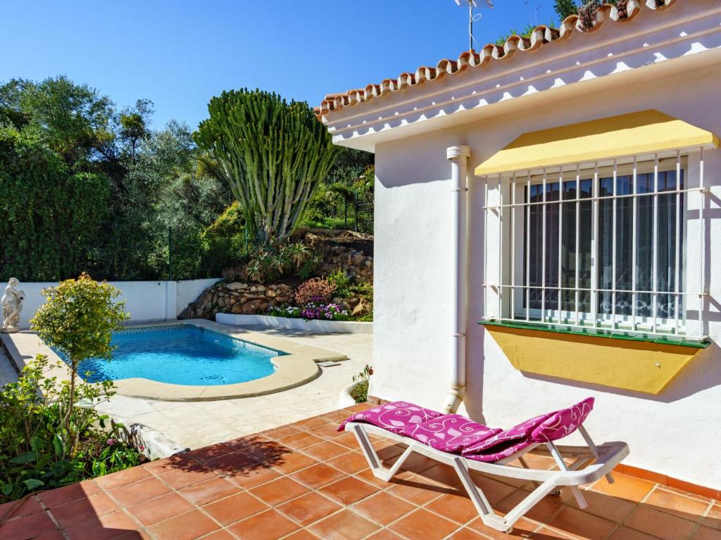uma casa com uma cadeira e uma piscina em Holiday Home El Chaparral by Interhome em Monda