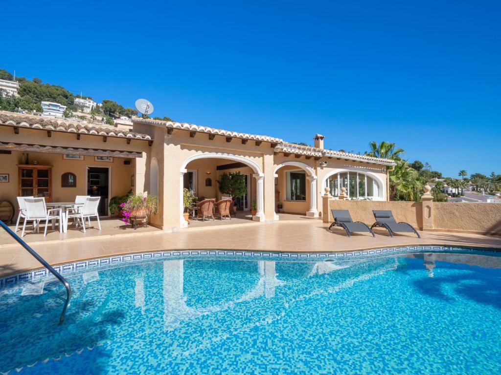 a swimming pool in front of a house at Villa Marita by Interhome in Moraira