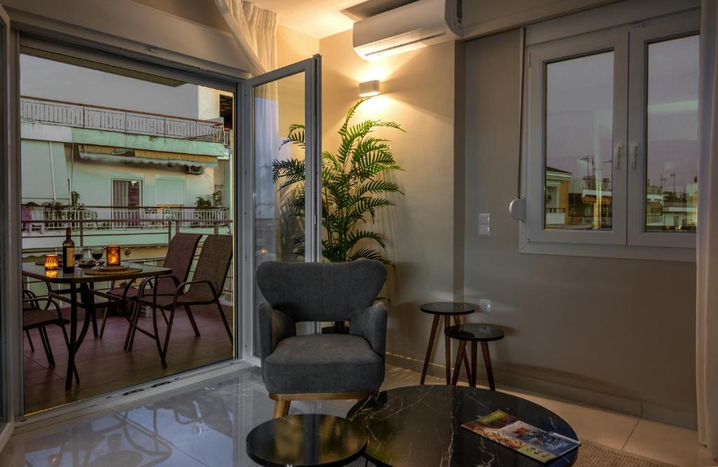 a room with a balcony with a table and chairs at NK Luxury Apartments in Preveza