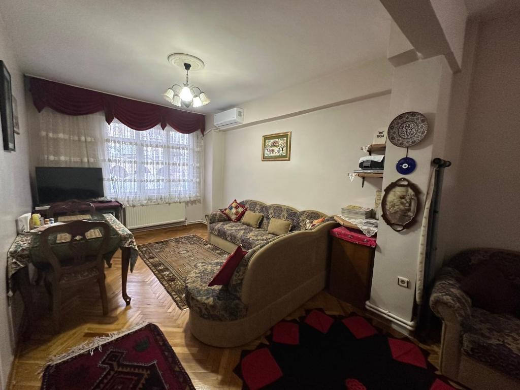 uma sala de estar com um sofá e uma cadeira em Nur home Abuzer Yegin em Istambul