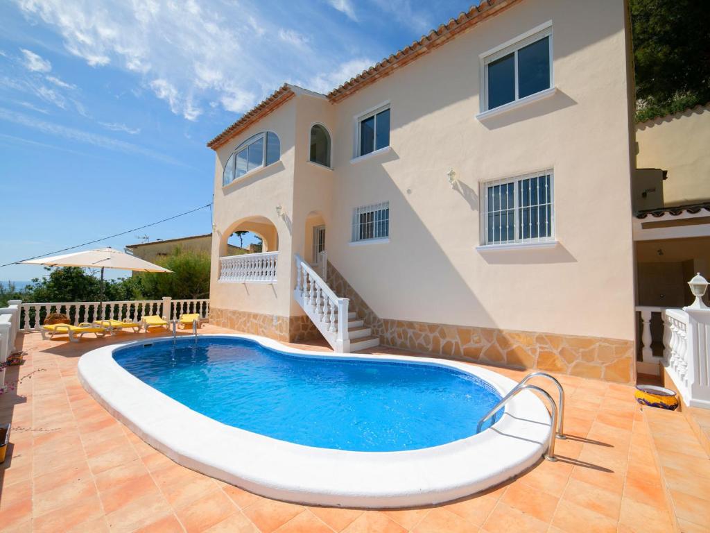 a villa with a swimming pool in front of a house at Holiday Home Mazo by Interhome in Benissa