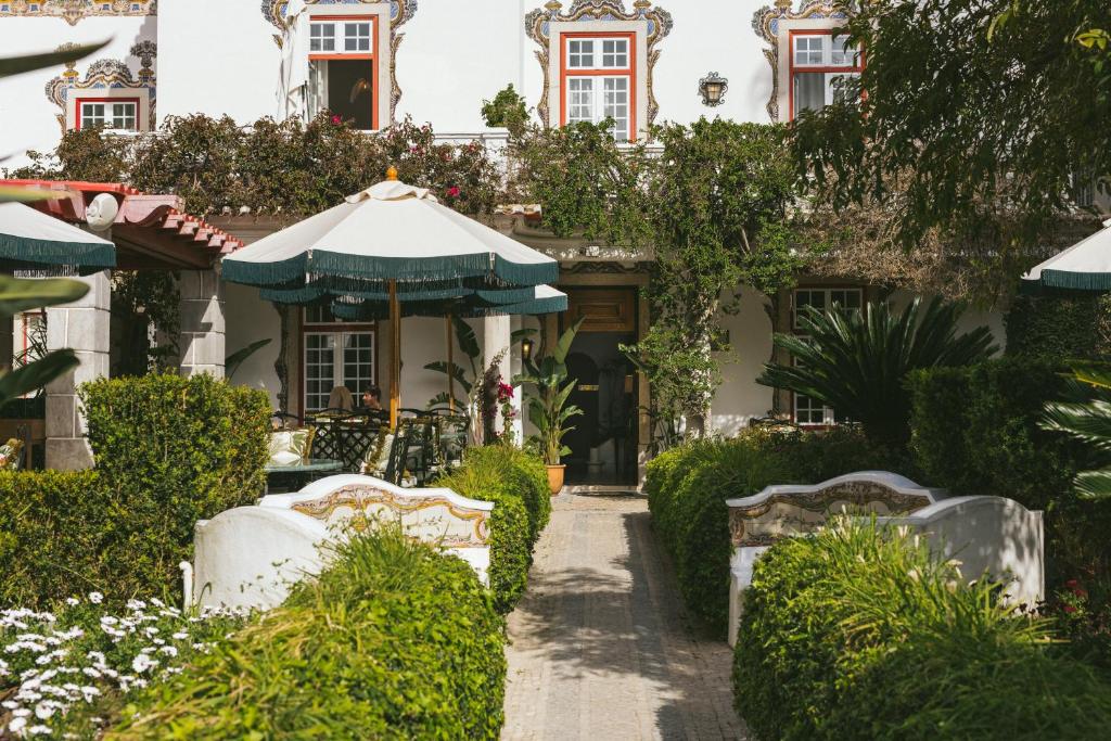 a garden in front of a house at Pergola Boutique Hotel in Cascais