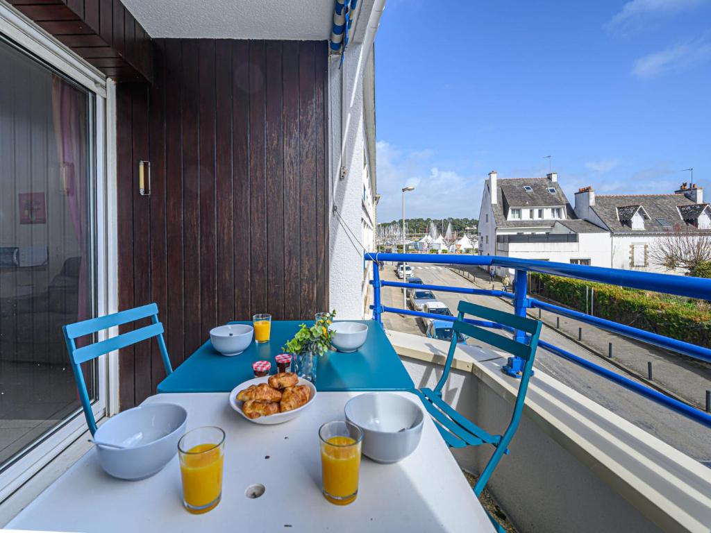 una mesa con un plato de comida en el balcón en Apartment Le Galion by Interhome, en La Trinité-sur-Mer