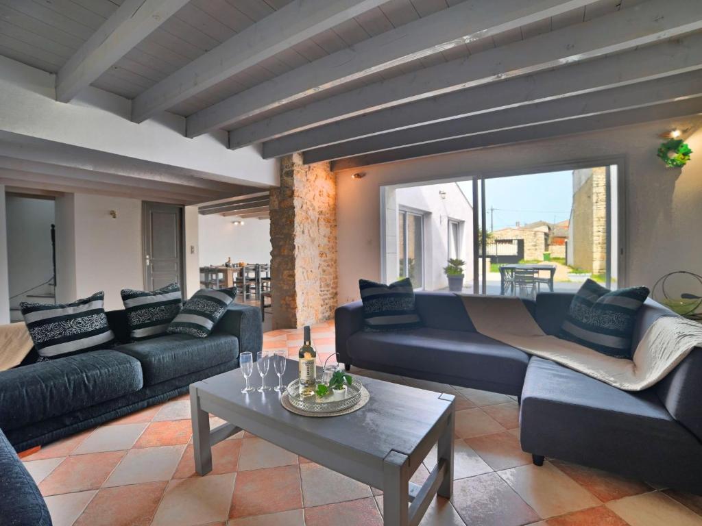 a living room with couches and a coffee table at Holiday Home Les Oyats by Interhome in Dolus d'Oléron