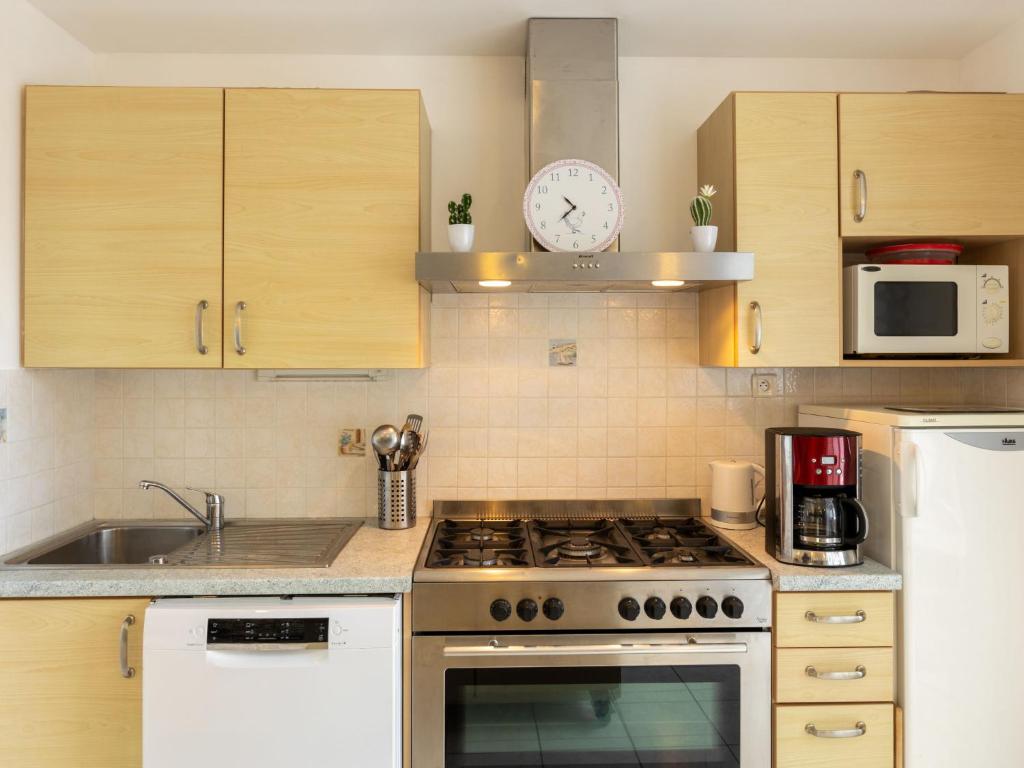 a kitchen with a stove top oven next to a sink at Holiday Home Coquelicot by Interhome in Saint-Méloir-des-Ondes