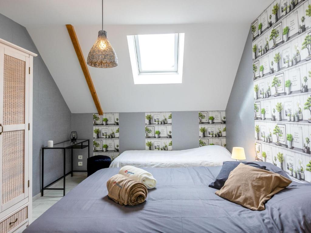 a bedroom with two beds and a window at Holiday Home Coquelicot by Interhome in Saint-Méloir-des-Ondes