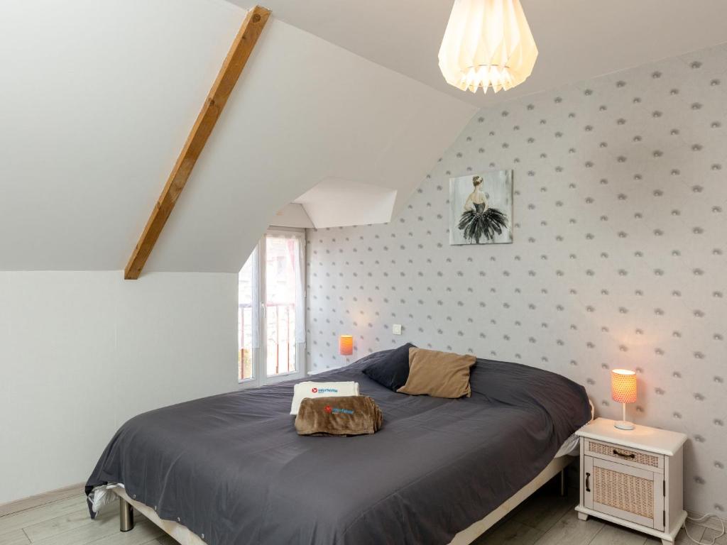 a bedroom with a large bed in a attic at Holiday Home Coquelicot by Interhome in Saint-Méloir-des-Ondes