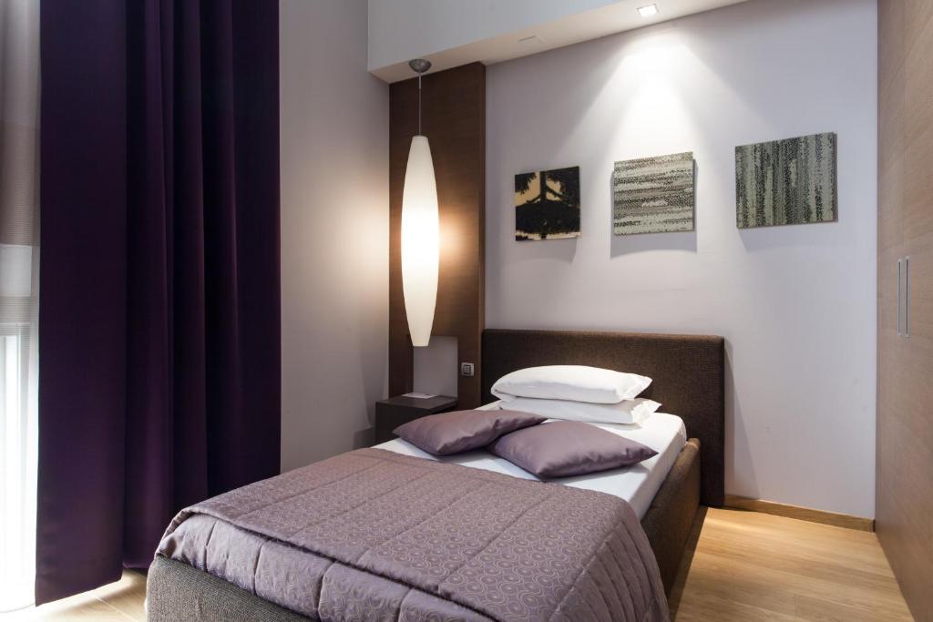 Postel nebo postele na pokoji v ubytování Hotel Michelangelo