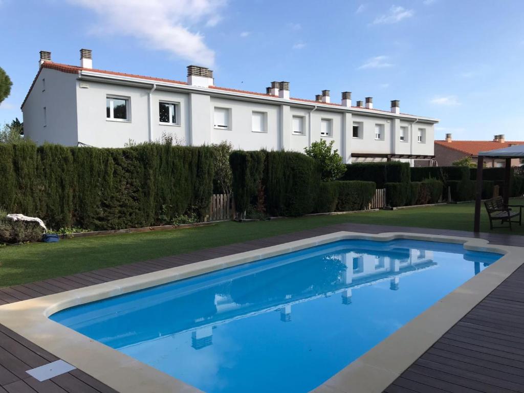 a swimming pool in front of a house at Casa con piscina Sant Pol de Mar in San Pol de Mar