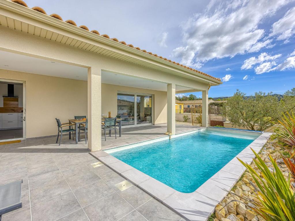 a villa with a swimming pool and a patio at Holiday Home Villa Hestia by Interhome in Goudargues
