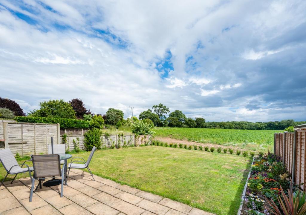 a patio with a table and chairs in a yard at Sailors Rest in Wangford