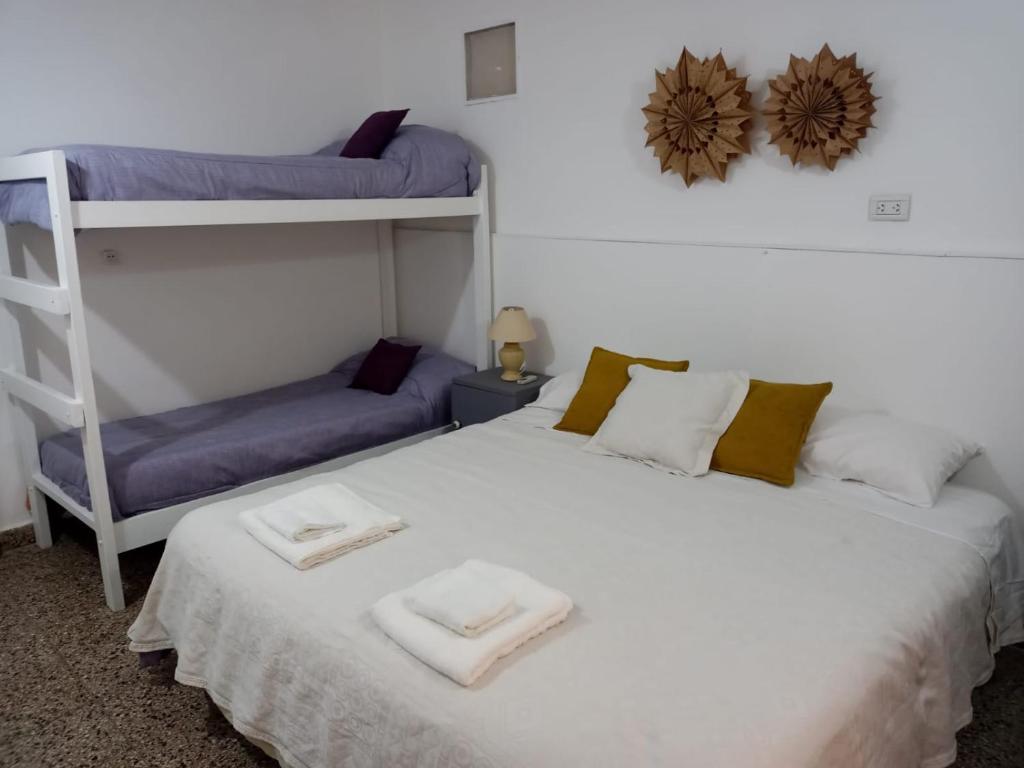 a bedroom with two bunk beds and a ladder at Cacique Catriel "EN PLANTA BAJA" in Catriel