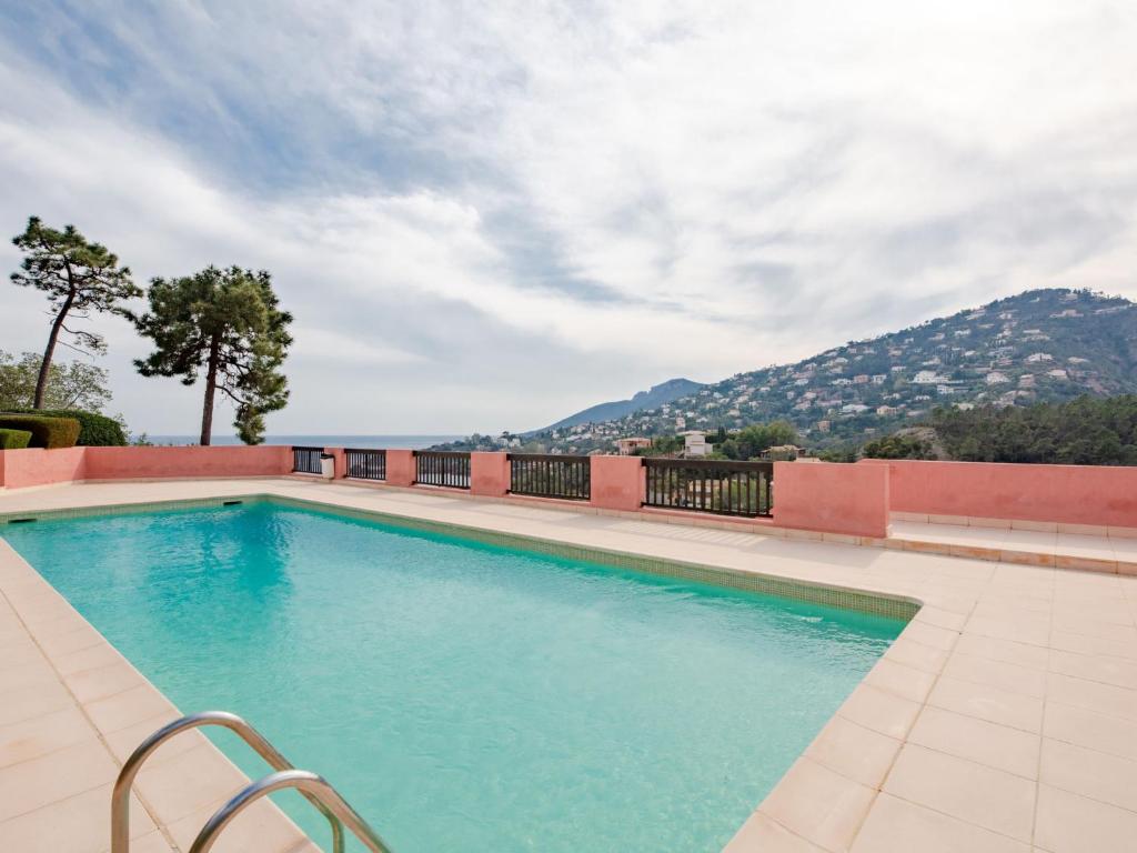 a swimming pool with a view of a mountain at Holiday Home Roche Rouge by Interhome in Théoule-sur-Mer