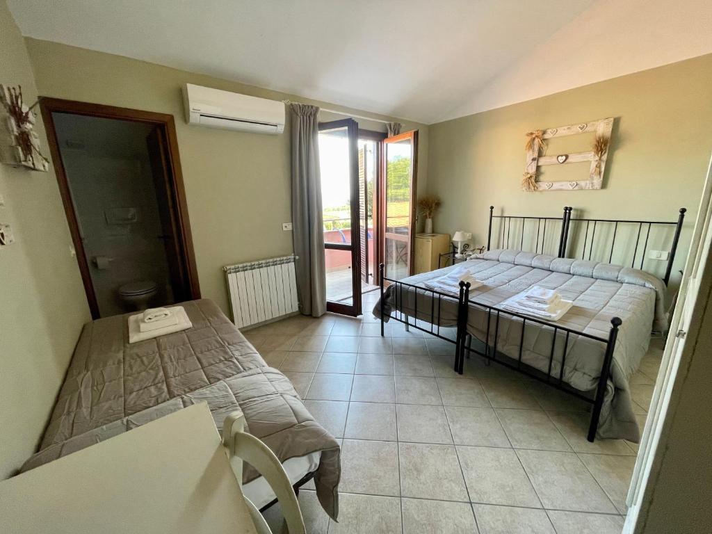Postel nebo postele na pokoji v ubytování I Puntoni Agriturismo