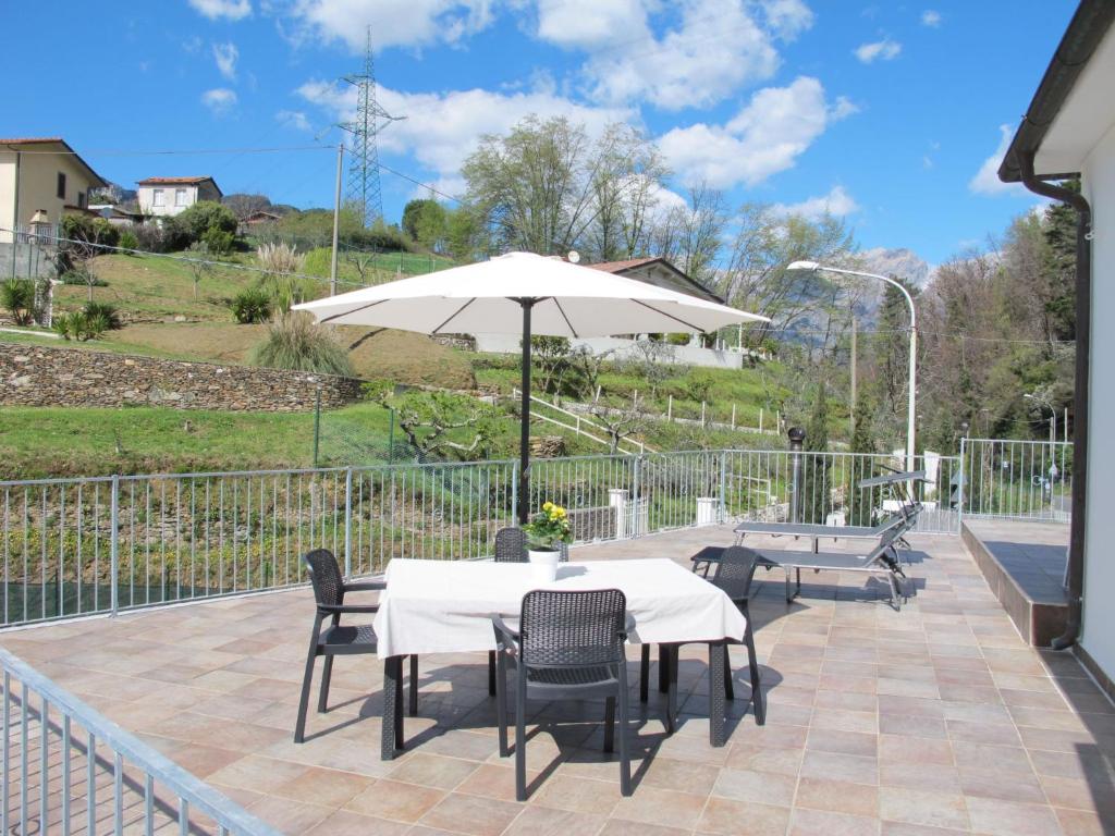 a patio with a table and chairs and an umbrella at Holiday Home Casa di Giò by Interhome in Marina di Massa
