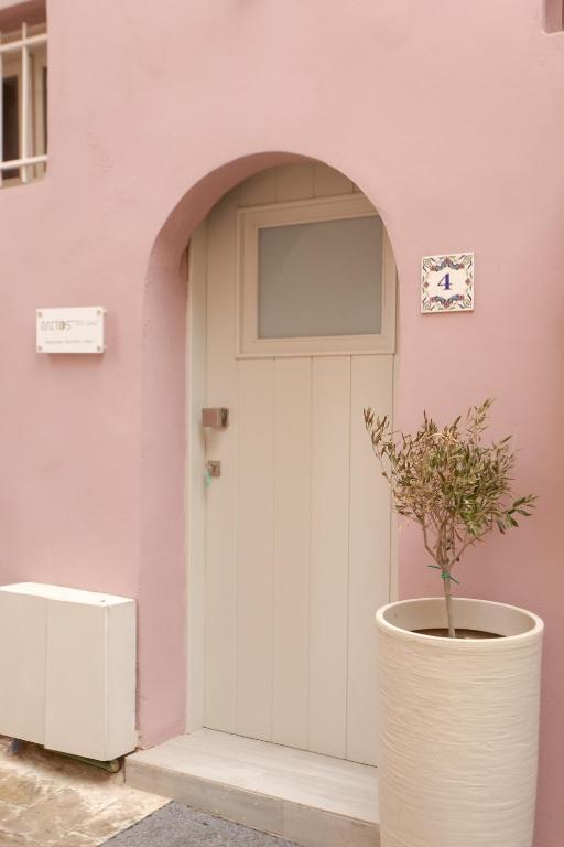 a plant in a pot next to a door at Mitos Cozy Rooms in Chania