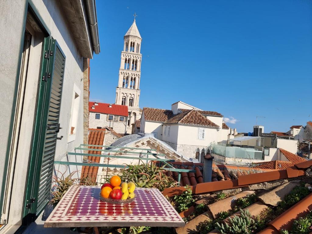 a bowl of fruit sitting on a table on a balcony at Malena Palace Experience in Split