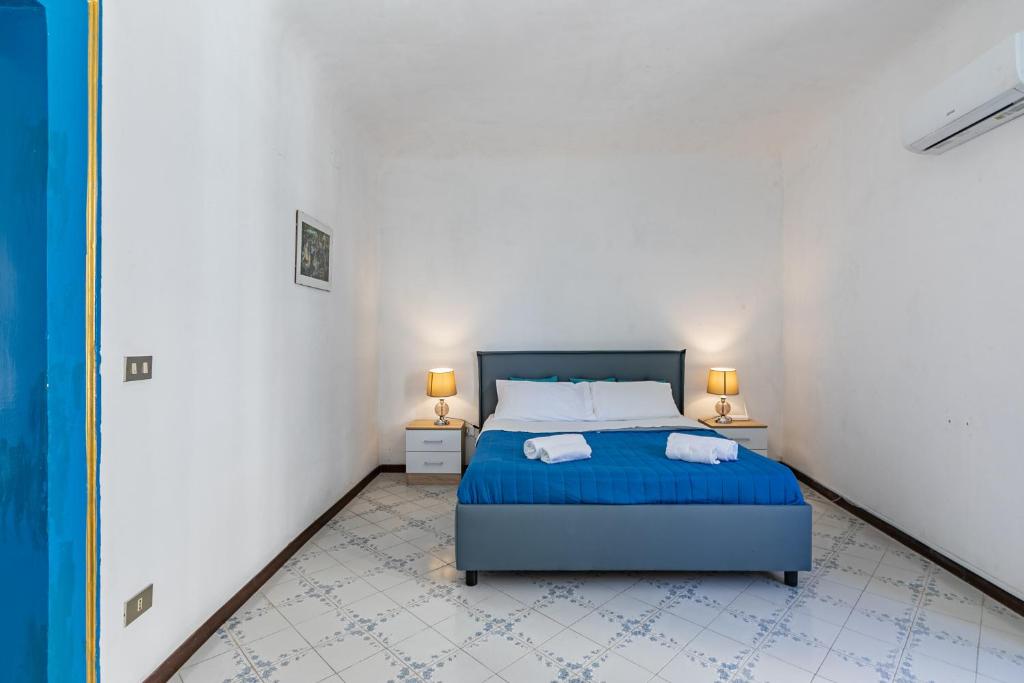 a bedroom with a bed with two towels on it at Piazza Pretoria & Quattro Canti Roomy Flats with Balconies in Palermo