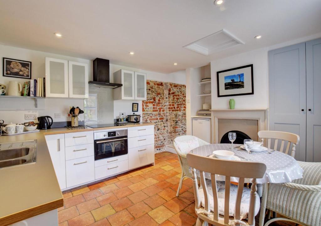 a kitchen and dining room with a table and chairs at The Old Mill in Snape