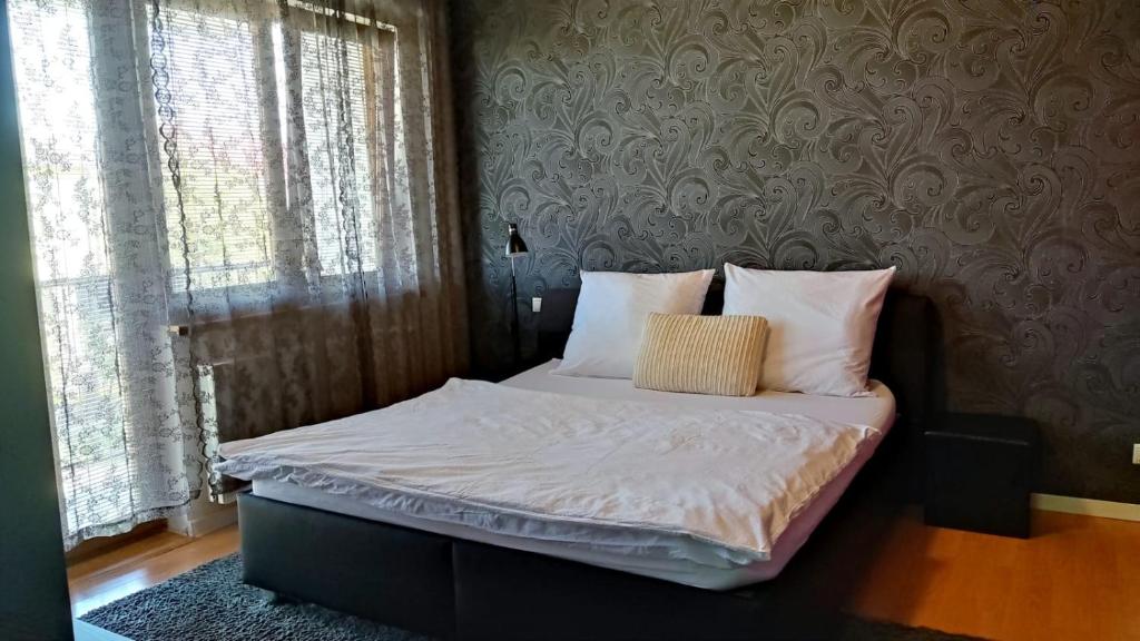 A bed or beds in a room at Penzion Ivka