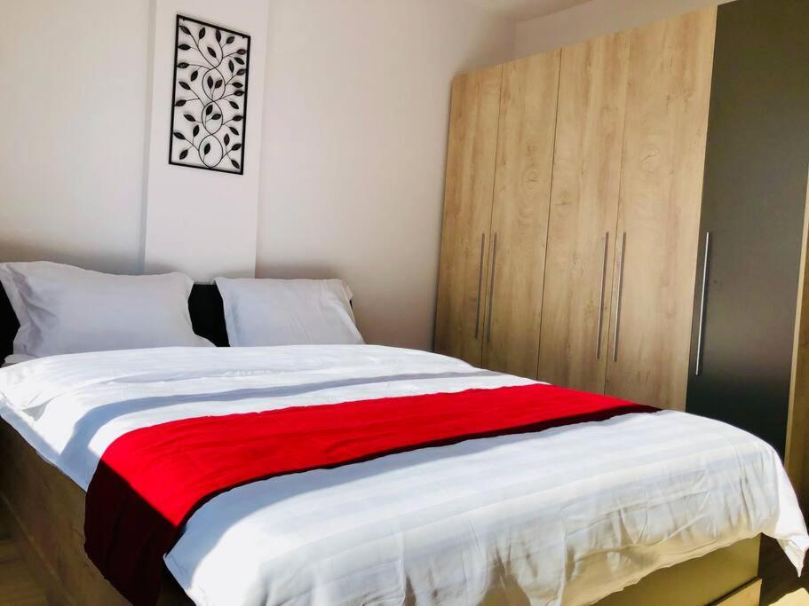 a bedroom with a large bed with a wooden cabinet at Joy City Stay Victoriei 7G-9 in Timişoara