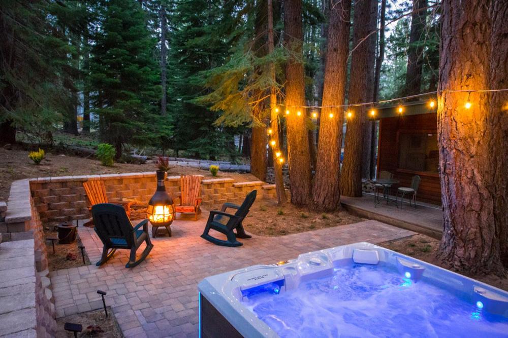 un jacuzzi en un patio trasero con un árbol en Fantastic Home In Woods With Hot Tub! en South Lake Tahoe