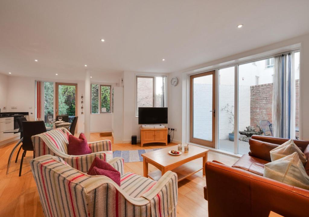 a living room with two couches and a television at Turnstones in Southwold