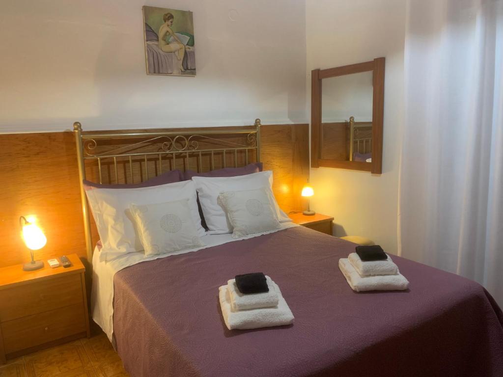 a bedroom with a bed with two towels on it at Diamanto's Home in Kastanéa