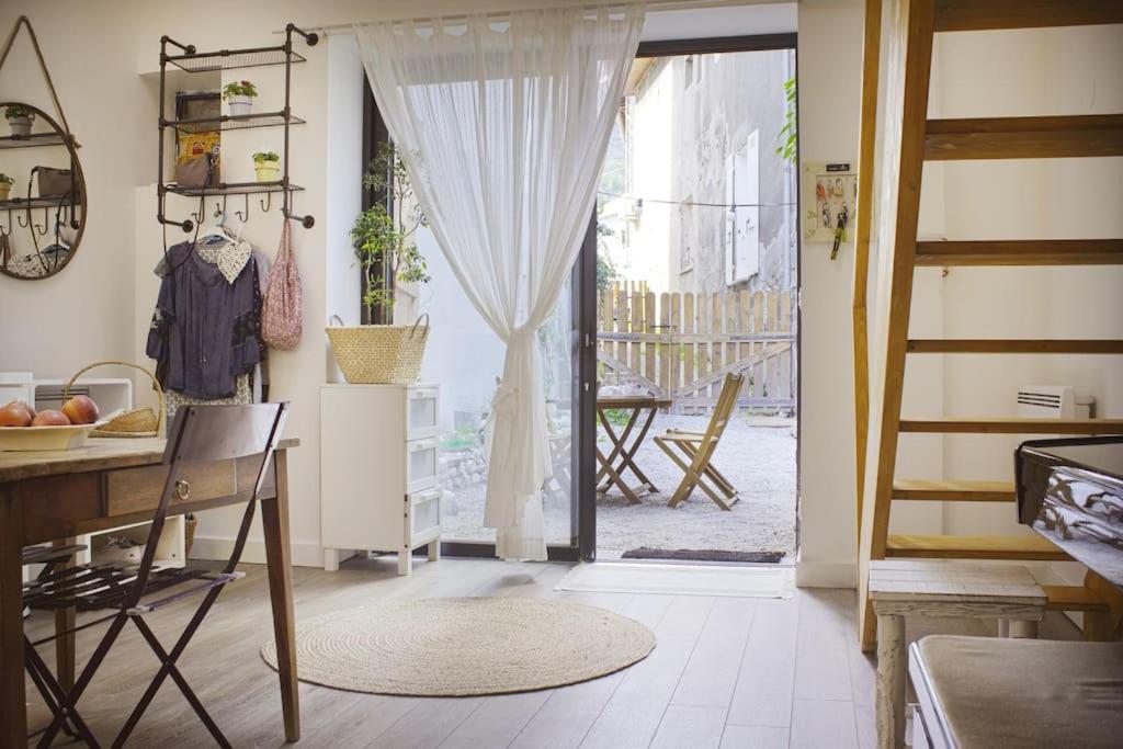 a kitchen with a door open to a patio at Duplex dans village avec jardin in Claix