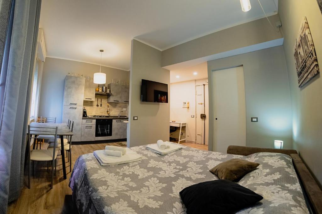 a bedroom with a bed and a living room at La maison di Roberto in La Spezia