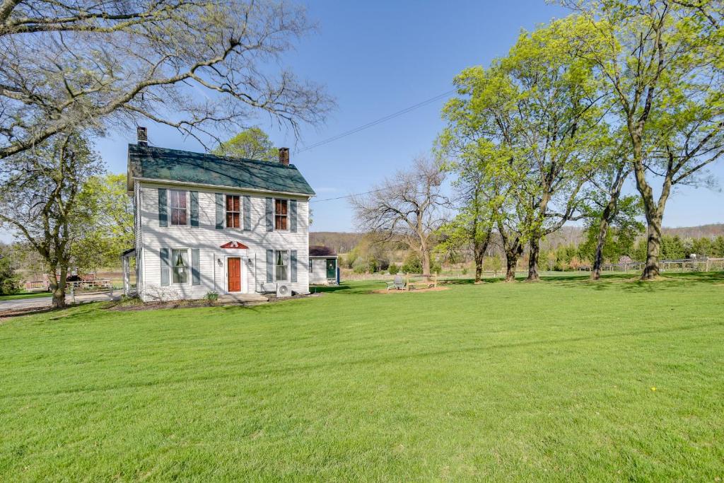 an old house with a large grassy field at Rustic Wellsville Home - 5 Mi to Roundtop Mountain 