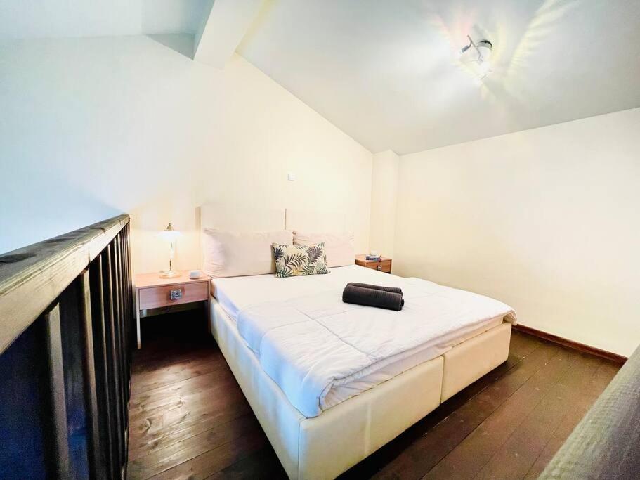 a bedroom with a large white bed in a room at Elegant modern loft in Kryopigi in Kriopigi