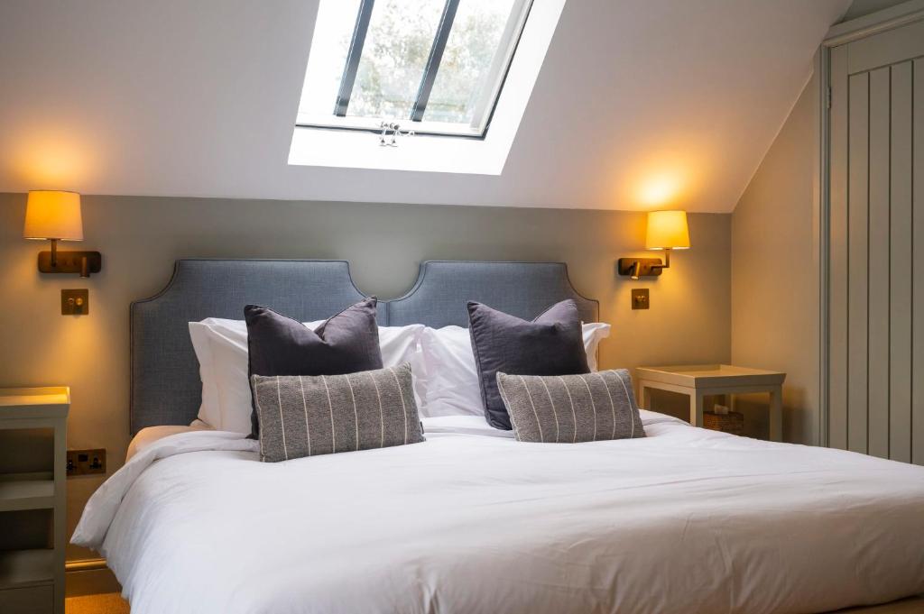 a bedroom with a large white bed with pillows at The Bottle & Glass Inn - Garden View - Room 1 in Henley on Thames