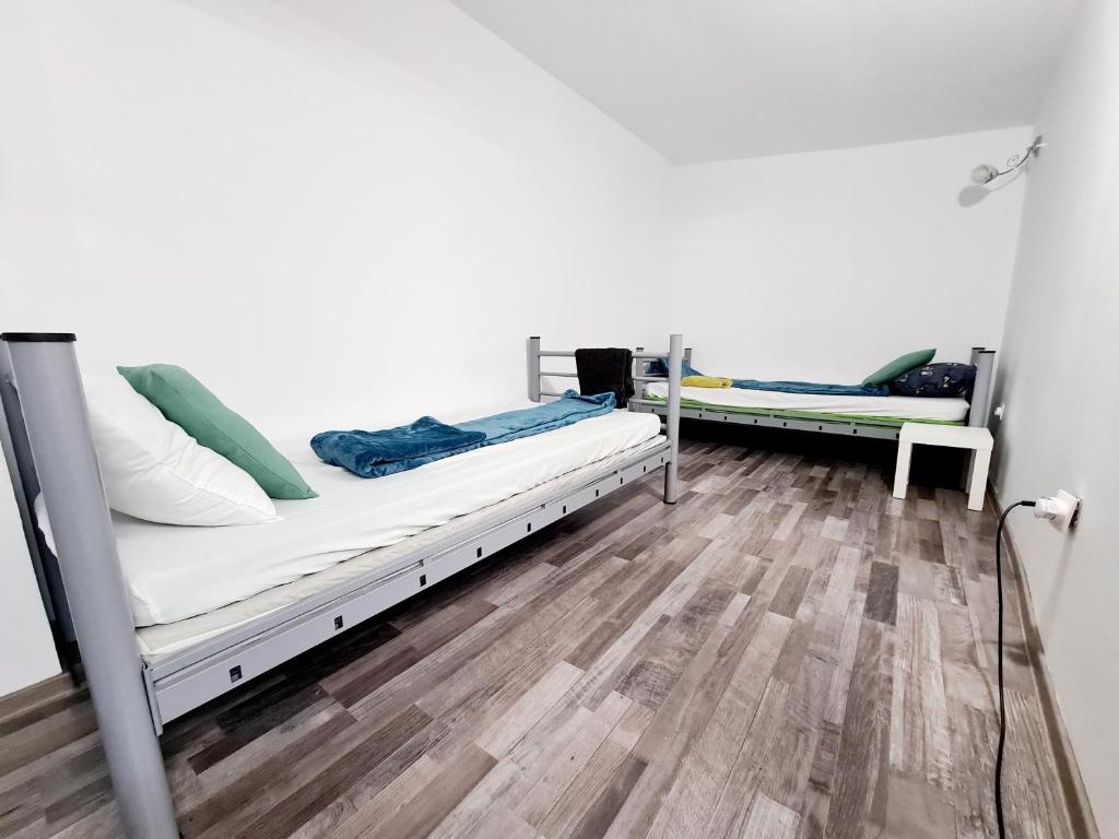 two bunk beds in a room with a wooden floor at Hostel Monument in Bucharest