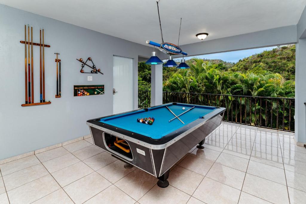 a pool table in a room with a balcony at Green Studio 1 - just 7 min drive to the beach in Rincon